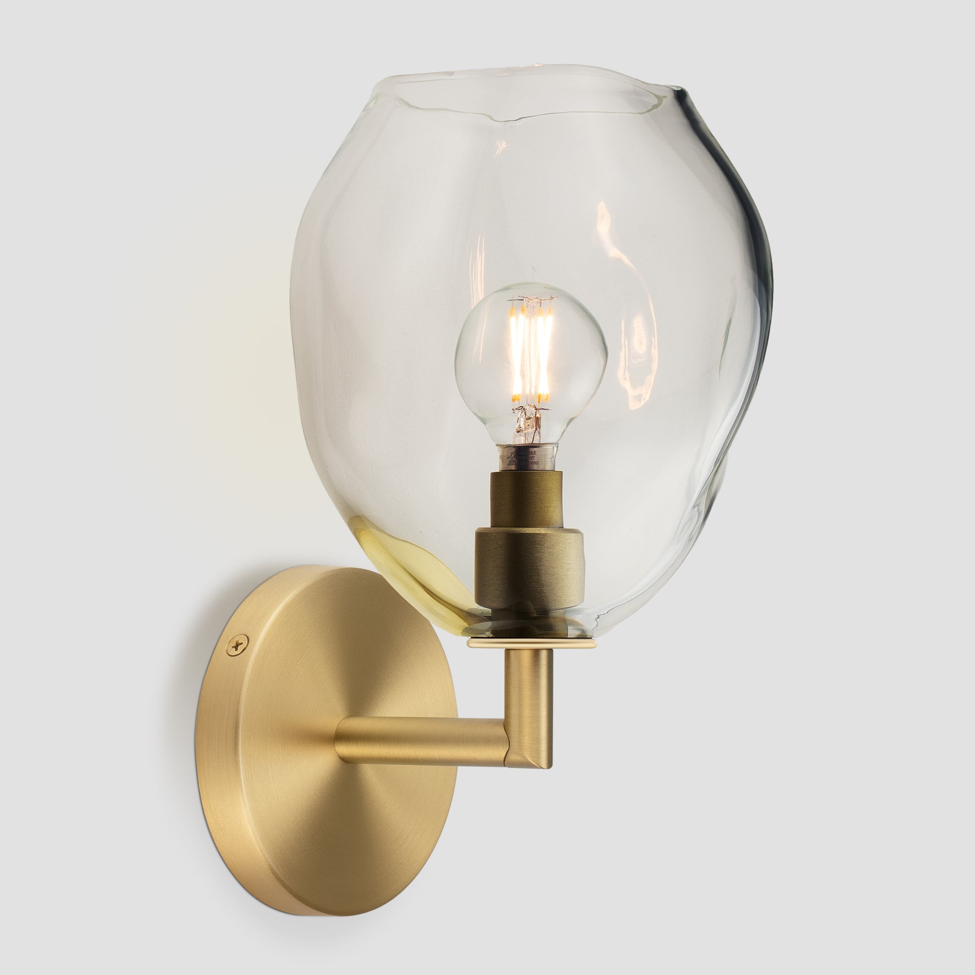 Wabi Sconce Clear Glass Brushed Brass Metal Round Canopy